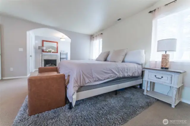 lovely primary suite with a sitting space and fireplace