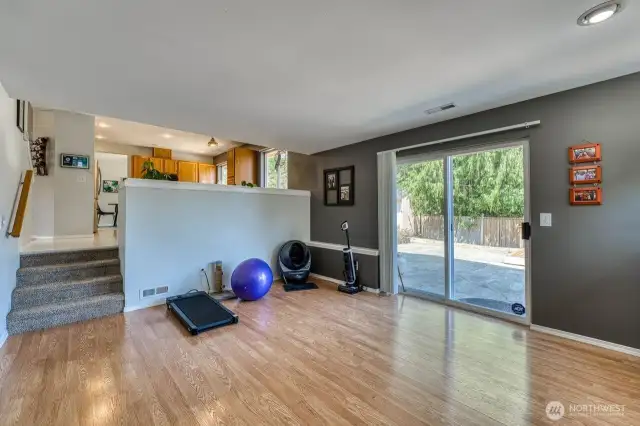 The slider opens to a spacious patio and elevated deck, with a peek-a-boo view of Seattle.