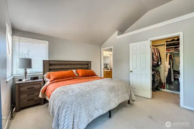 The primary looking to 1 of two walk in closets. The bathroom door om the far left.