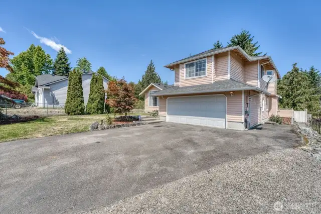 The large driveway provides ample off-street parking and there is RV parking on the side with a power hook up.