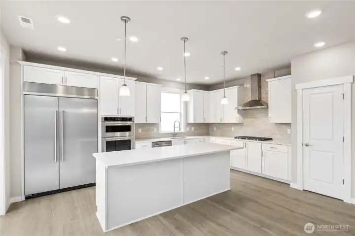 Gorgeous kitchen with tons of space to prepare!  48" counter depth refrigerator, built in microwave & oven + gas cooktop!