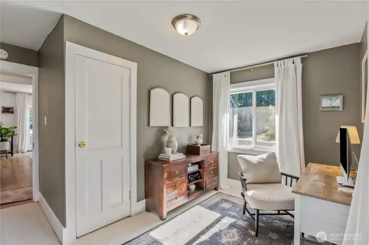 Main-level bedroom doubles as a light-filled home office or flex space. Perfect for remote work or creative use.