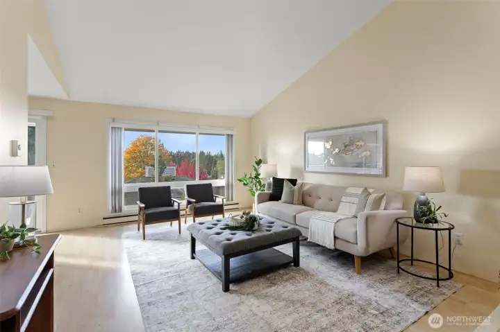 West facing living room with vaulted ceilings and lots of light flowing in through oversized windows!