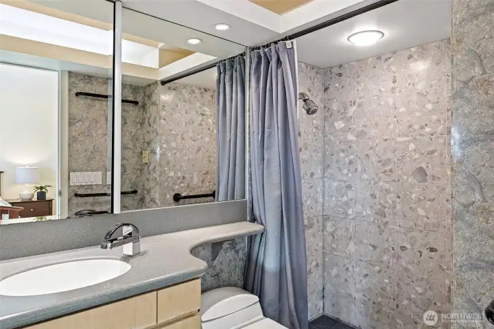 Primary bathroom with heated floors. Dated finishes and tons of mirrors! Custom vaulted ceiling with lighting.