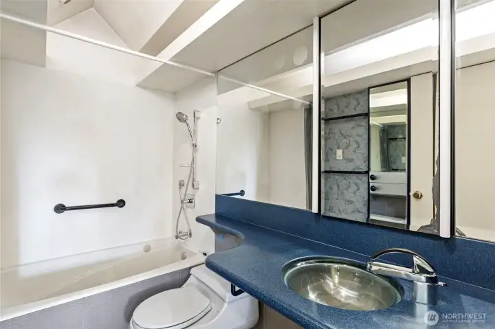 Bathroom with jetted tub and heated floors. Custom vaulted ceiling with lighting & lots of mirrors. Very retro!