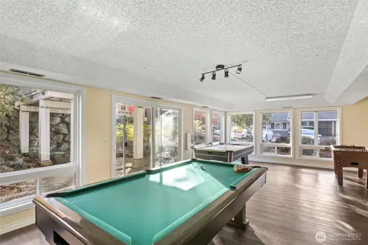 Game room in lower level of clubhouse with outdoor patio featuring privacy and koi ponds