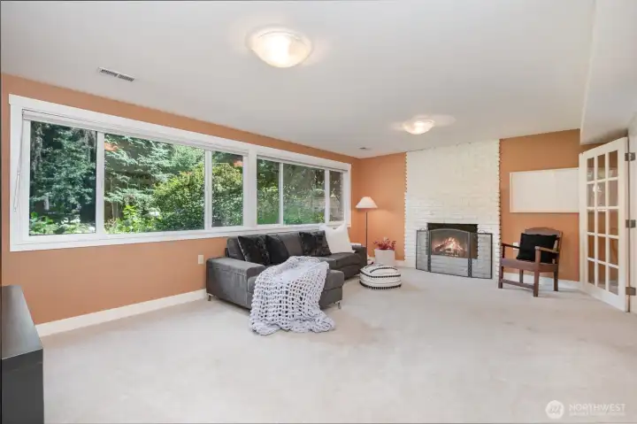 Fireplace on lower level and French doors leading to bedroom.