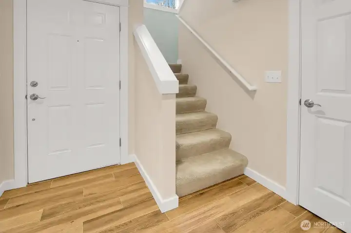 Close up of gorgeous tile that is in the entry and kitchen. Door on the right leads to the amazing storage closet under the stairs.