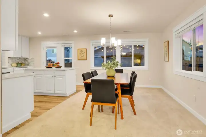 Plenty of room to gather in the dining room. Look at that custom millwork around the windows and doors!