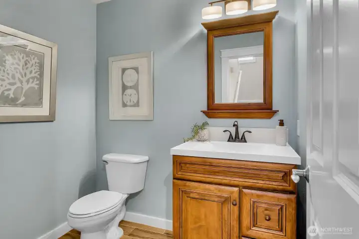 Updated powder room located at the foot of the stairs just off the entry.