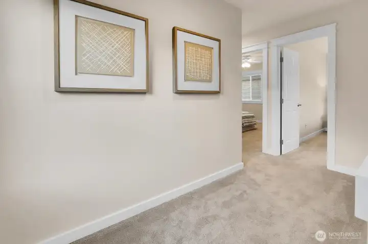 Bright and wide landing at the top of the stairs.