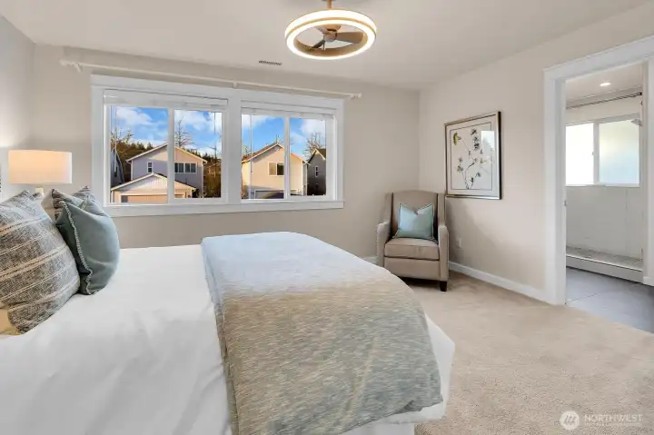Primary suite leading to spa-inspired bath. Notice that the custom millwork continues throughout the home.