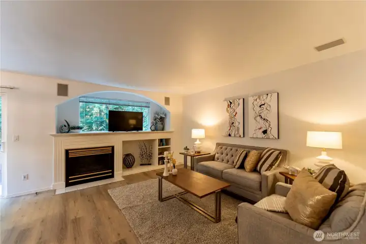 Beautiful open concept living space with gas fireplace and new harwood floors.