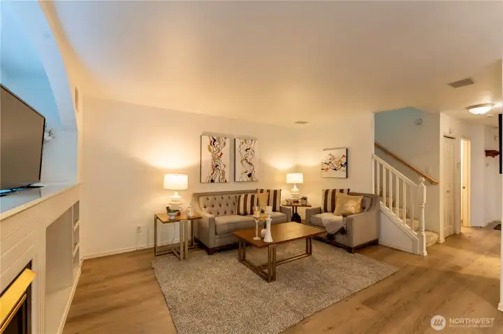 Beautiful open concept living space with gas fireplace and new harwood floors.