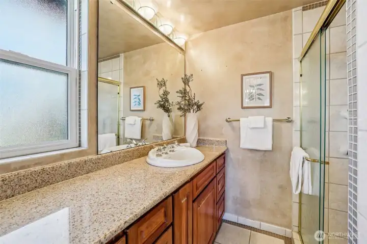 Ensuite bathroom features twin sinks with shower in the middle.