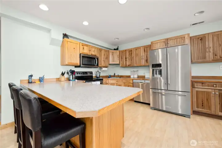 The beautiful maple kitchen cabinets allow for an abundant amount of storage. There is a double closet in the hallway used as the pantry. Additional eating space set up at the kitchen counter.