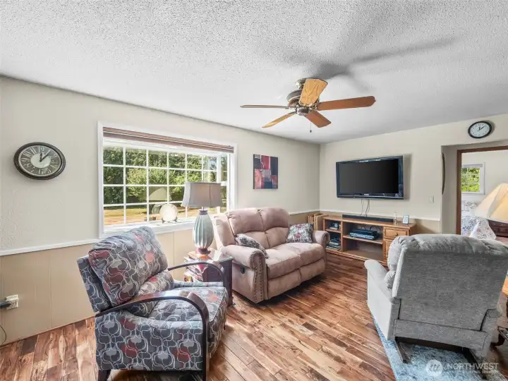 family room with wood burning stove and entry to primary hallway and bedroom