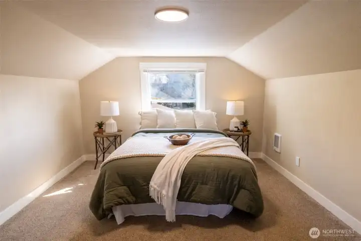 The upstairs primary bedroom is spacious and private - a true santuary!