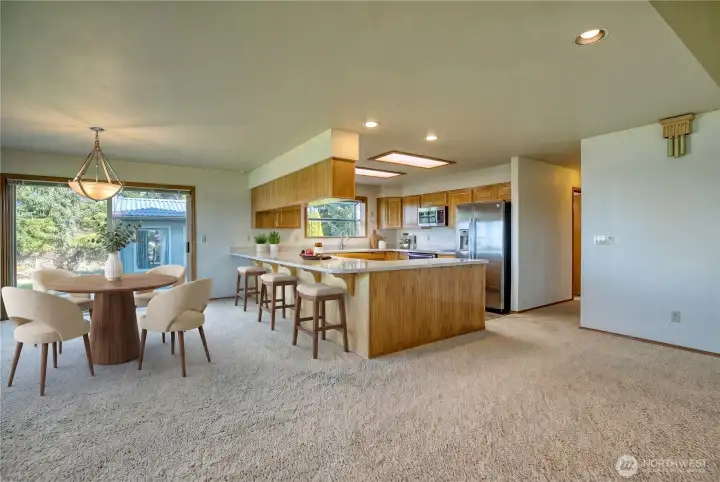 Dining space and kitchen, virtually staged