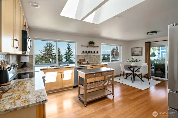 Large kitchen with huge picture windows and access to the side deck
