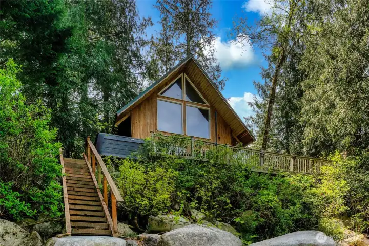 The iconic A-Frame situated perfectly on the high bank. This nature retreat looks out over 100ft +/- of your own private shoreline.