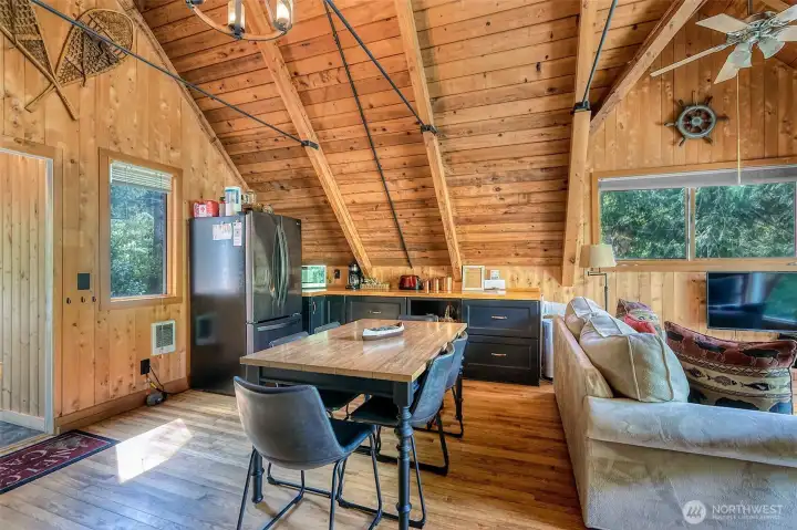 Opposite the main kitchen wall is abundant cabinetry, and an expansive counter that anchors the dining space. It provides incredible storage and the perfect surface for entertaining.