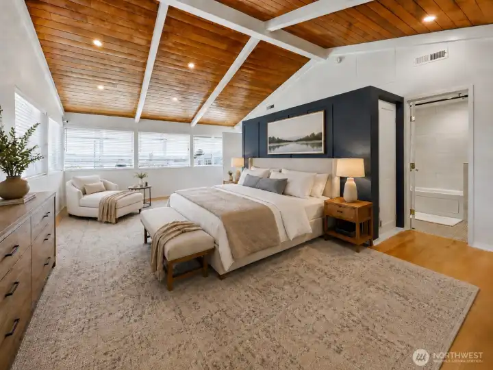 A flexible, light-filled suite space currently used as a family room can also serve beautifully as a spacious primary retreat with en-suite bath and laundry.