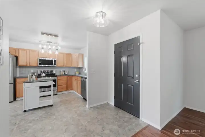 Front door open to spacious kitchen...
