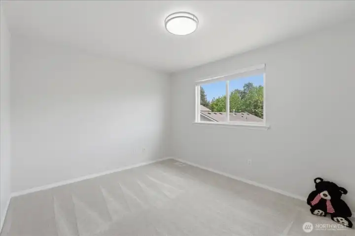 Well-sized second bedroom, with new doors installed throughout the entire home.