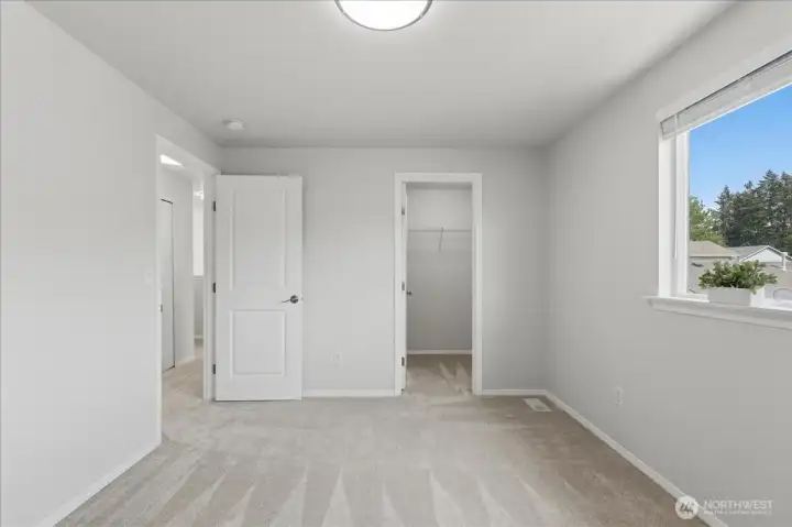 Third bedroom with walk-in closet; all bedrooms include walk-in closets.
