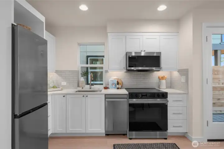 LVP floors paired with full tile backsplash making cleaning up a breeze! LVP floors paired with full tile backsplash making cleaning up a breeze!