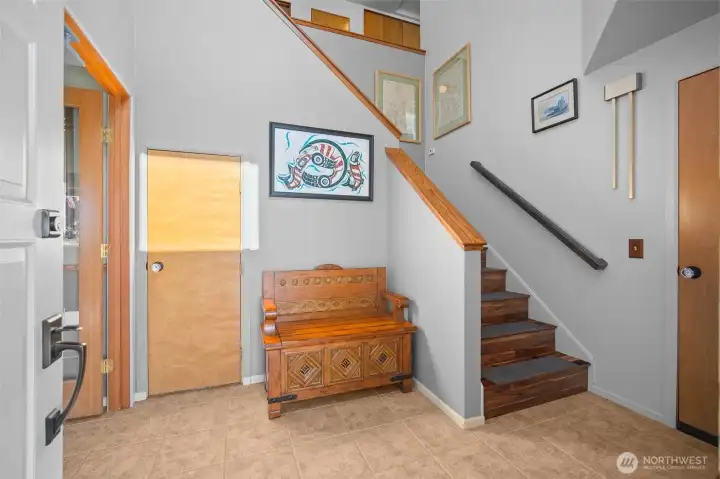 The main entry on the lower level with the garage entry on the right, and office or guest space on the left The main entry on the lower level with the garage entry on the right, and office or guest space on the left