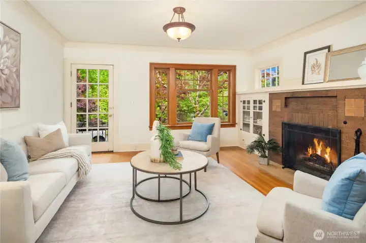 View of the living room from dining room side. Note the beautiful wood-trimmed front window, and OWC moldings.