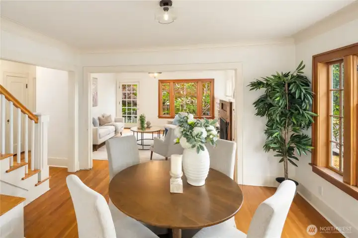 Overview of dining and living rooms, with peek of the stairs to upper level.