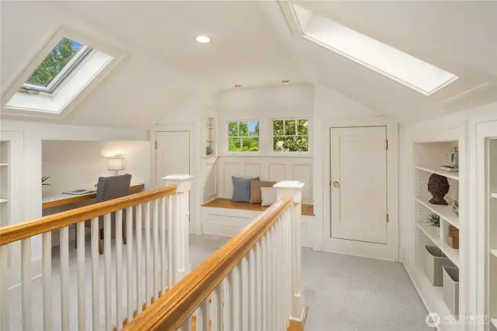 As you reach the upstairs landing, the many built-ins will delight you. There's a built-in window seat with storage and display nooks, a built-in desk, and several built-in bookcases. Skylights keep the area light and bright. Plumbing extensions can be found in the eaves for a future bathroom of your creation.