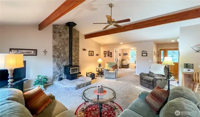 Spacious great room with cozy wood stove with stone hearth and vaulted beam ceilings. Great room is open to the den/office or tv room and dining room..