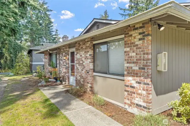 Private walk to the front door~you will love the tall trees that provide shade and privacy