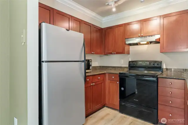 Beautiful cherry shaker cabinets, granite counters, and love that smooth top stove!