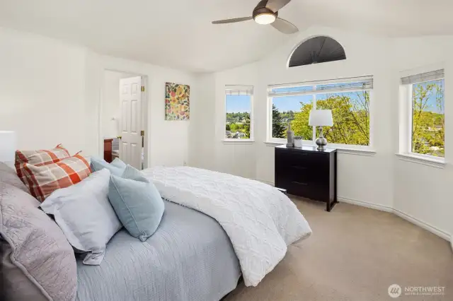 A room with a view! The light and bright primary suite has vaulted ceilings, a walk-in closet, and an attached bath. Don't worry, there is AC (new in 2021).
