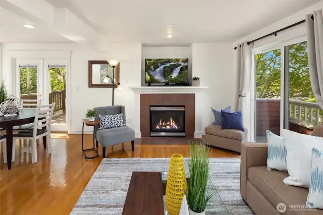 Another view of the light-filled living room and the gas fireplace.