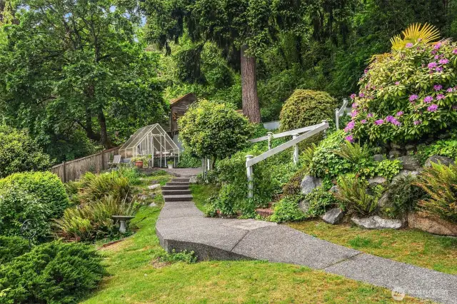 Beautifully landscaped grounds leading to a green house.