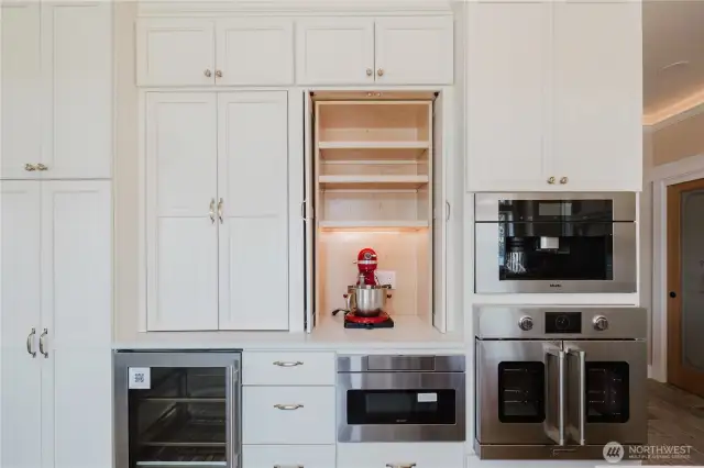 State of the arts kitchen has 2 baker stations tucked into behind pocket doors, Miele coffee maker, wall ovens, built in drawer for microwave and much more to delight a cook.