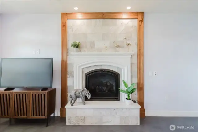 What a master piece!! The rec room's  full height fireplace in Turkish Travertine marble and art deco carved cherry trim will delight and keep the room cozy warm.