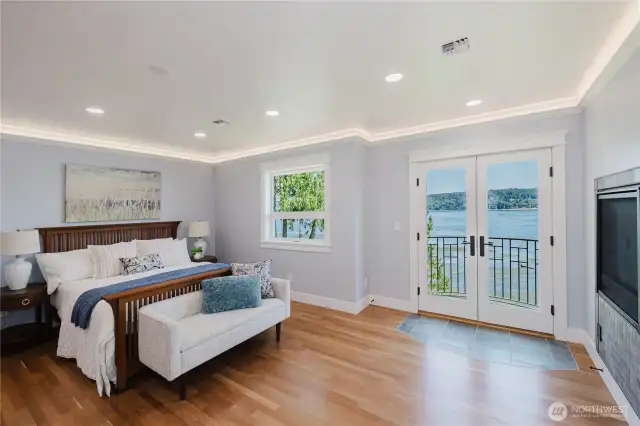 The very spacious primary bedroom with double doors out to the balcony.