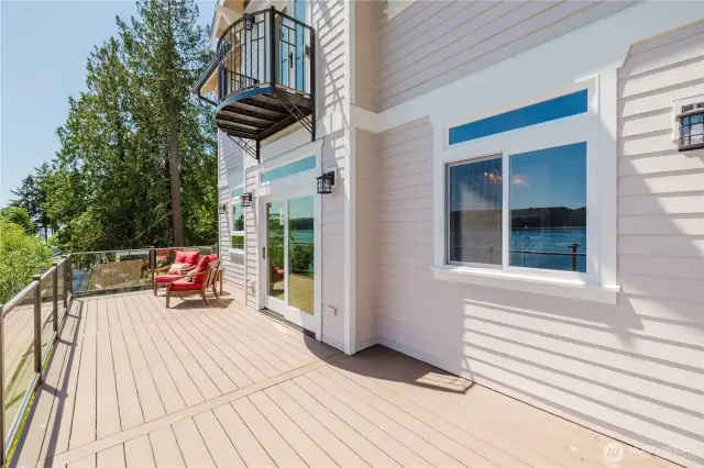 The full width upper deck includes duplex outlets, porch lights and a rain collection system which keep the lower level deck dry and comfortable.