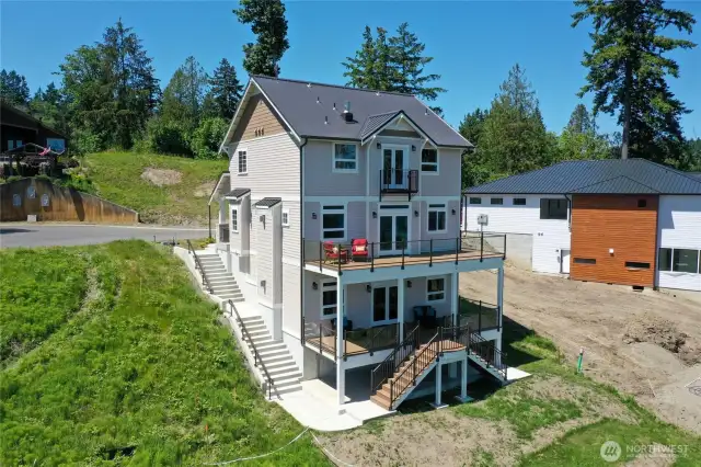 The home has 3 floors, a lower deck and main floor deck and a balcony off the primary bedroom.