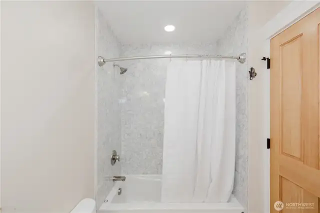 Beautiful quartz surround the jetted tub and shower.