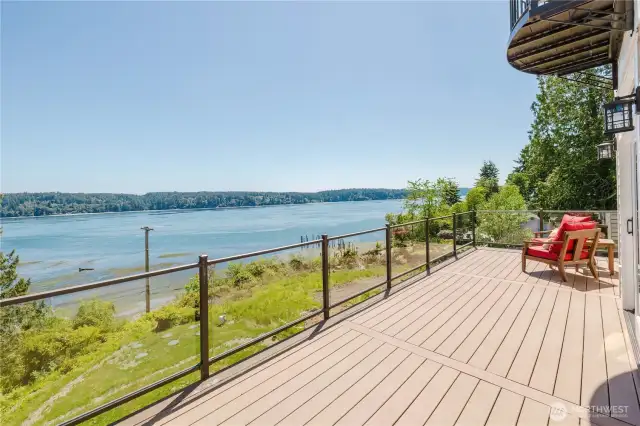 The expansive main floor deck is accessible from the living room and offers plenty of space for outdoor grilling and lounging