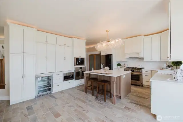 The kitchen is a chef's delight with 2 refrigerators, 6 burner gas stove, farmhouse sink & touchless faucet. Miele appliances, 2 baker prep stations, built in coffee maker. All this and a sweeping view of the Sound and Mt. Rainier.