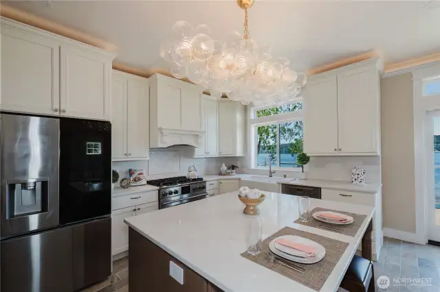 A beautiful kitchen with quartz covered island and counters .